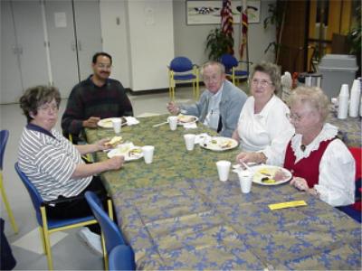 Coin club members eating and enjoying the benefit of coin club membership