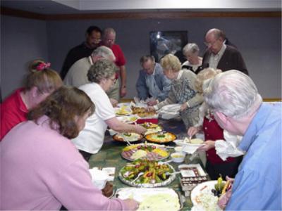 Coin club members eating and enjoying the benefit of coin club membership